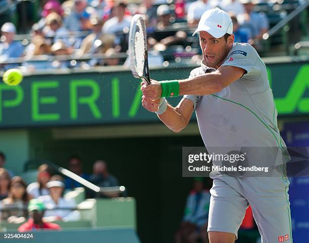 Novak Djokovic of Serbia returns a shot against Andy Murray of Great Britain during their match on Day 10