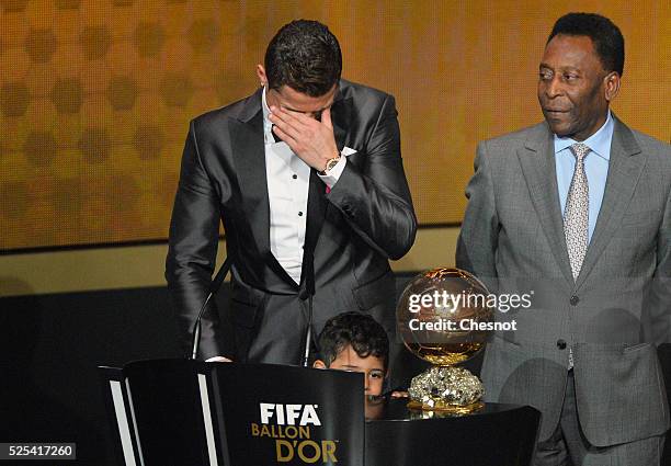 Real Madrid's Portuguese forward Cristiano Ronaldo cries after receiving the 2013 FIFA Ballon d'Or award for player of the year from Brazilian...