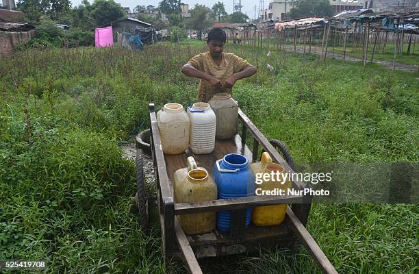 Years old Indian boy, Sonu put water into his cart to be use in hotel on World Day Against Child labour in Dimapur, India northeastern state of...