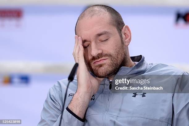 Tyson Fury reacts as Wladimir Klitschko speaks to the media during Tyson Fury and Wladimir Klitschko head to head press conference on April 28, 2016...