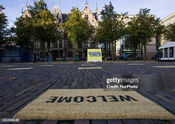 In front of parliament on Thursday Amnesty International laid out 400 doormats to draw attention to the refugee problem ahead of a debate on the...