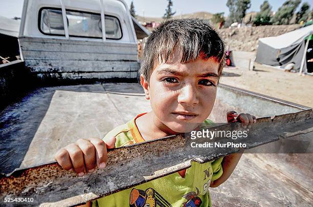 Young boy waits near the food distribution centre in Zahko refugee camp, one of the largest camps in Kurdistan, Iraq. The UN's World Food Programme...