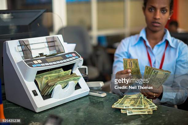 Cash withdrawal of Ethiopian Birr at a bank in Addis Ababa. Most everyday transactions in Ethiopia, both large and small, require cash. Ethiopia...