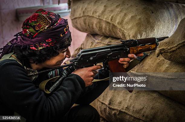 Female fighter of the Syrian Kurdish People's Protection Units is seen during fighting against Islamic State pictured on 21 December 2014 in the...