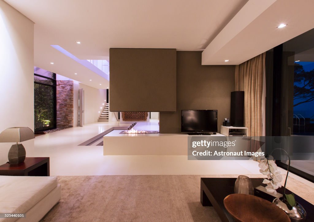 View of fireplace in luxurious living room during night