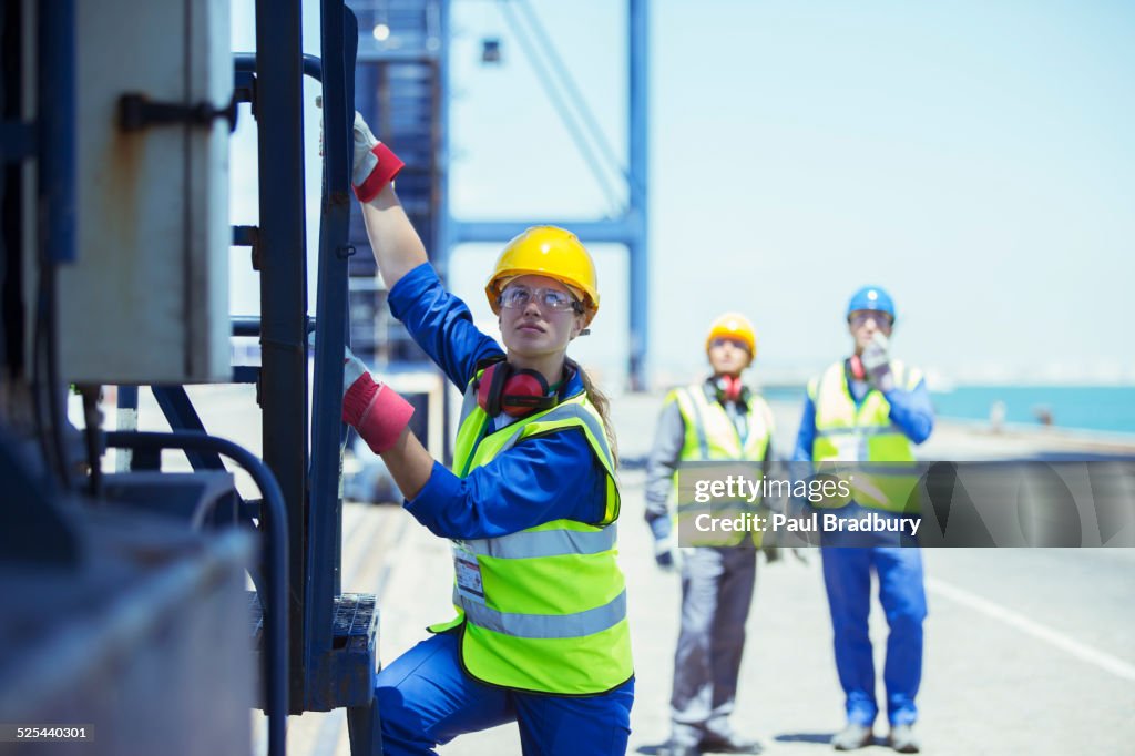 Worker climbing cargo crane