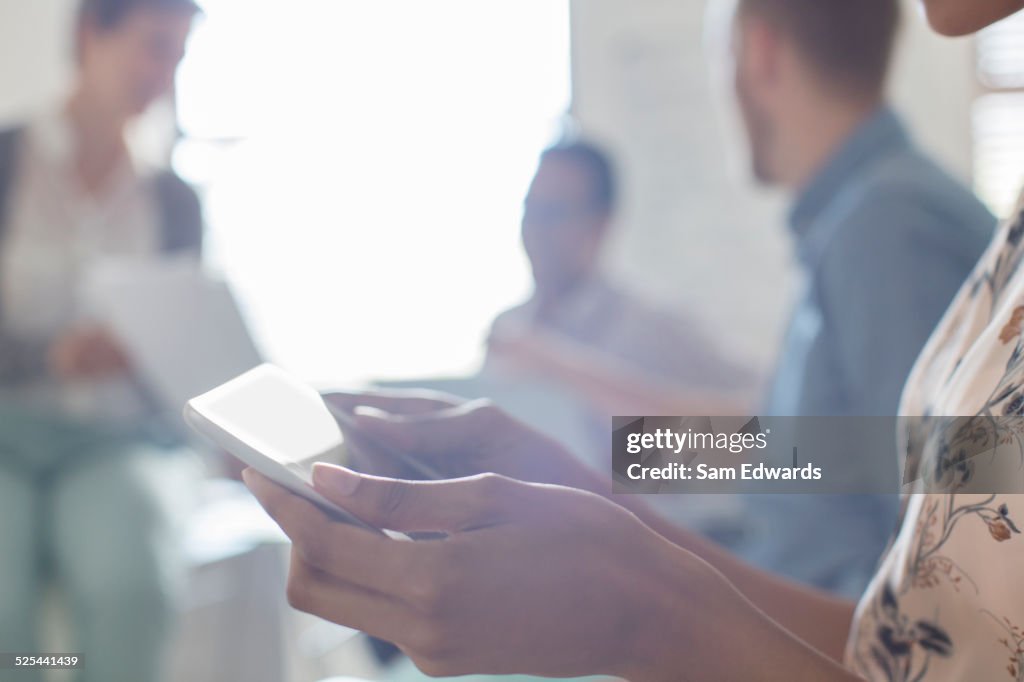 Business people working in office, using digital tablets