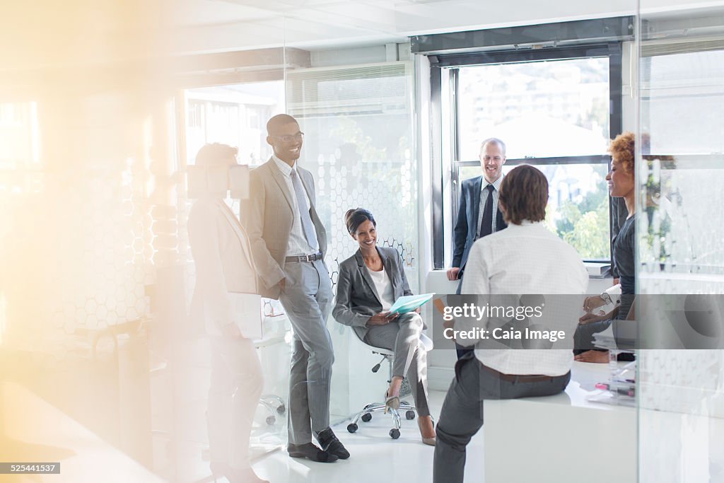 Smiling business people having meeting in modern in office