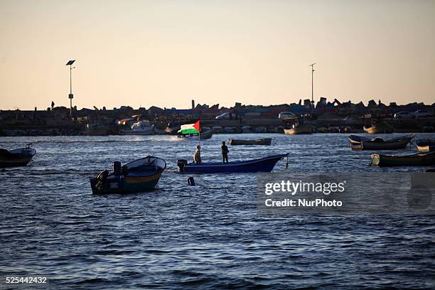 Young Palestinians on their boat made from remnants of empty plastic bottles inside the port of Gaza City on April 19, 2015