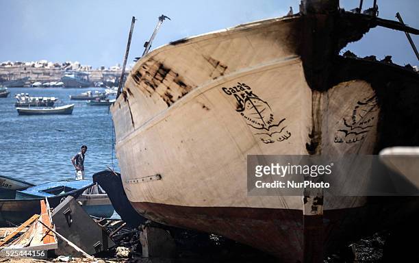 Smoke rises from the peace activists boat 'Gaza's Ark' following an Israeli air strike during the fighting between Israeli navy and Hamas militants...