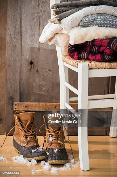 studio shot of snow boots and folded blankets - moon boot stock pictures, royalty-free photos & images