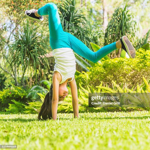 usa, florida, jupiter, girl (8-9 ) doing cartwheel on front yard - cartwheel stock pictures, royalty-free photos & images