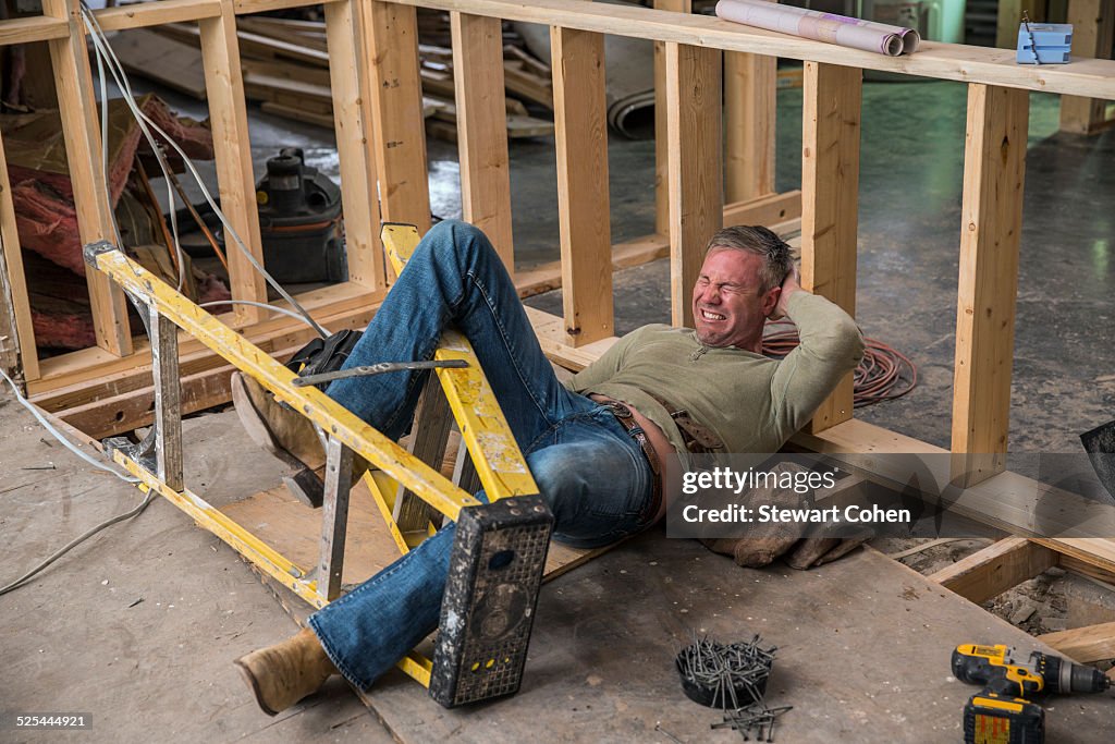 USA, Texas, Dallas, Construction worker falling of ladder inside new structure