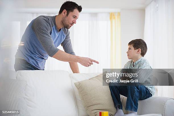 usa, new jersey, jersey city, father disciplining son (8-9) - berispen stockfoto's en -beelden