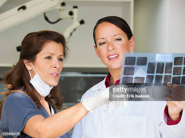 usa, california, mission viejo, dentist and assistant looking at x-ray - endodontist ストックフォトと画像