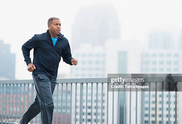 usa, new jersey, jersey city, man running in city - males running stock pictures, royalty-free photos & images