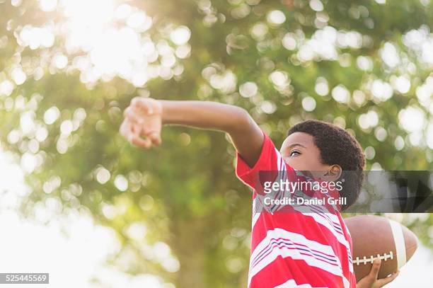 usa, florida, jupiter, boy (6-7 ) playing football - throwing stock pictures, royalty-free photos & images