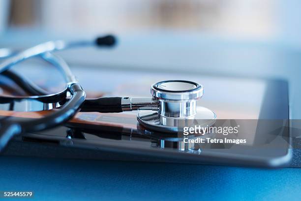 usa, new jersey, jersey city, close up view of stetoscope on digital tablet - medical instrument stock pictures, royalty-free photos & images