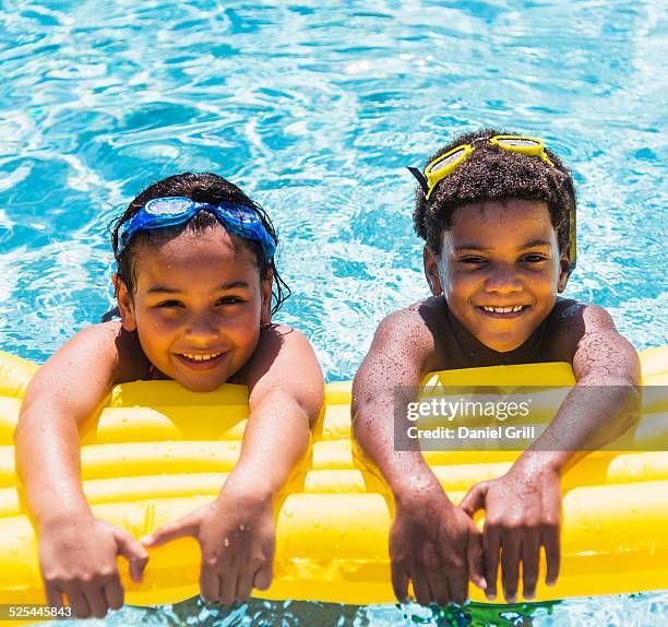 Girl Playing On Inflatable Raft In Swimming Pool Photos and Premium ...