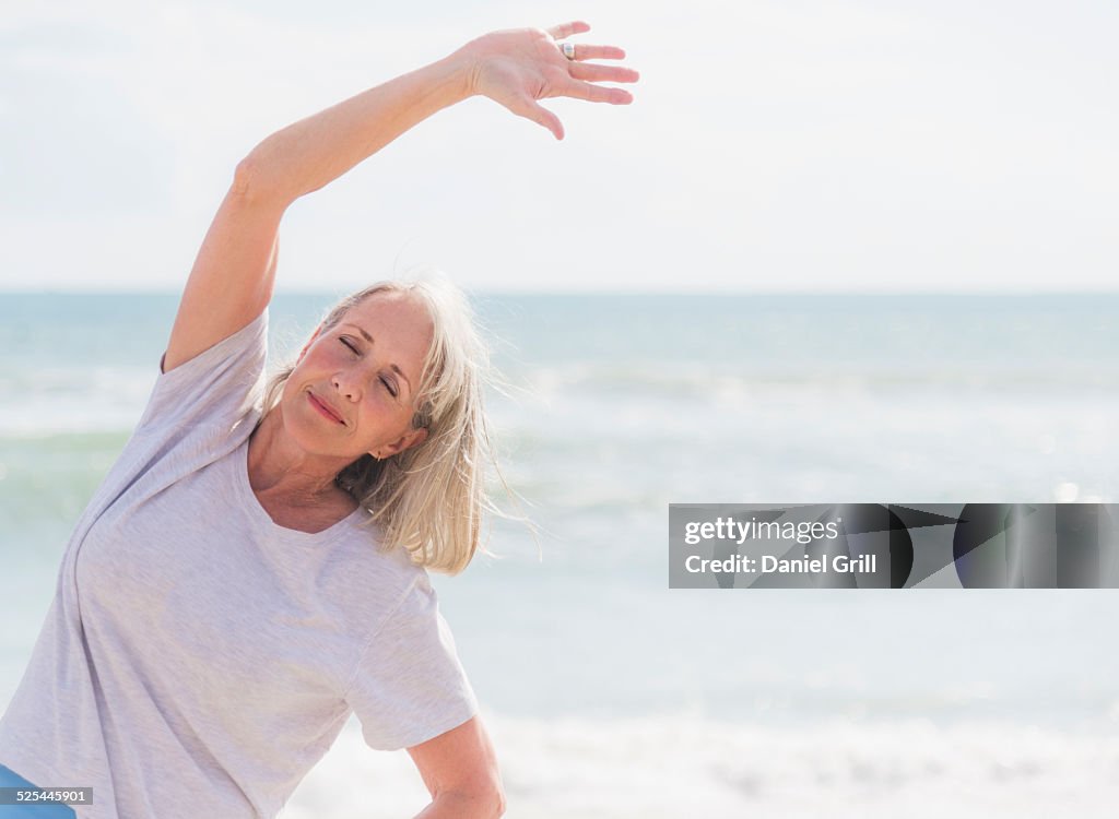 USA, Florida, Jupiter, Senior woman exercising on beach