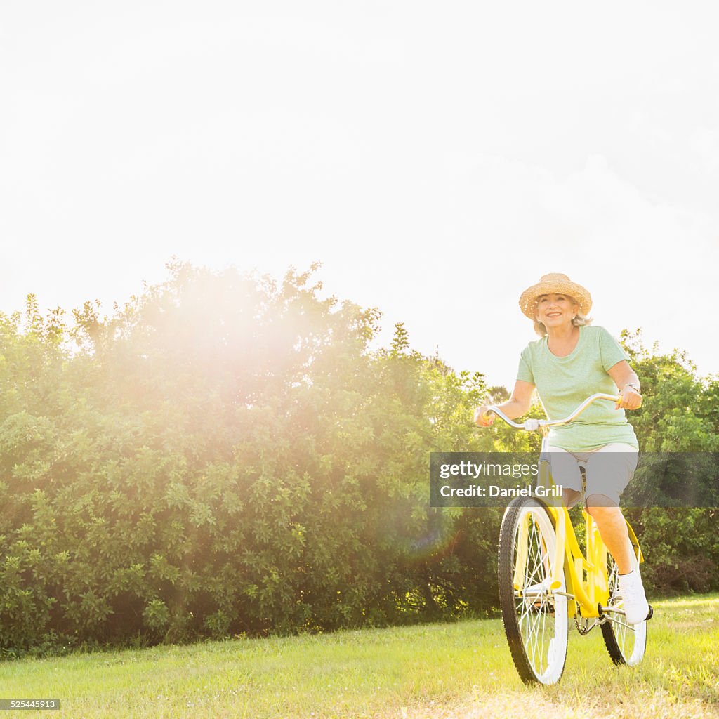 USA, Florida, Jupiter, Senior woman on bike