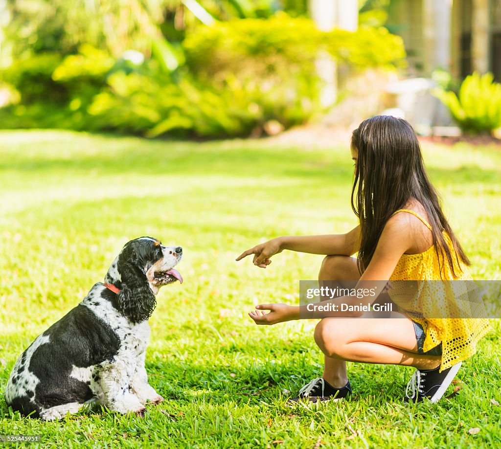 USA, Florida, Jupiter, Girl ( 8-9 ) teaching dog tricks