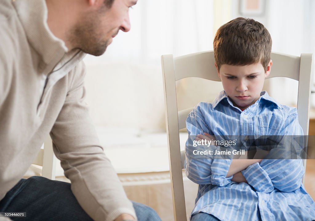 USA, New Jersey, Jersey City, Father looking at displeased son (8-9)