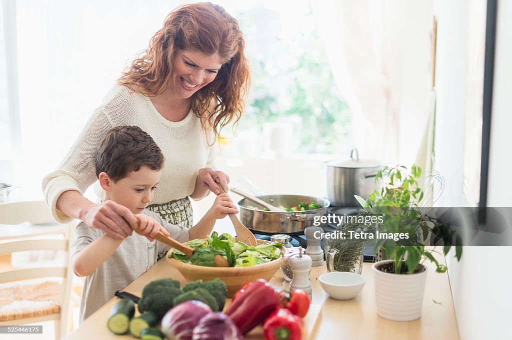 USA, New Jersey, Jersey City, Mother and son (6-7) cooking together