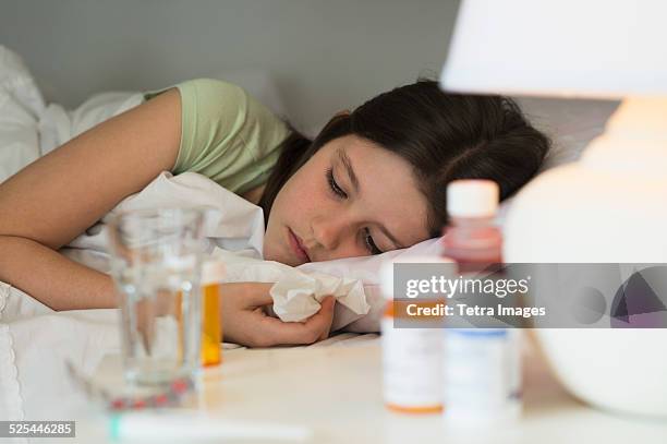 usa, new jersey, jersey city, sick girl (8-9) lying in bed - bedside table kid asleep stock pictures, royalty-free photos & images