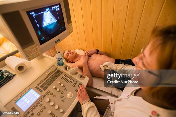 Sonographer doing ultrasonography for ATO soldier in Military Hospital, Ukraine. During Ukrainian-Russian conflict military hospitals overloaded for...