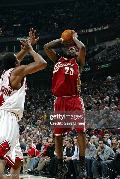 LeBron James of the Cleveland Cavaliers puts up a shot over Othella Harrington of the Chicago Bulls during the second quarter of the NBA game on...