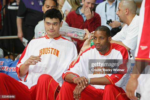 Yao Ming and Tracy McGrady of the Houston Rockets sit on the bench during the game with the Sacramento Kings at Arco Arena on March 13, 2005 in...