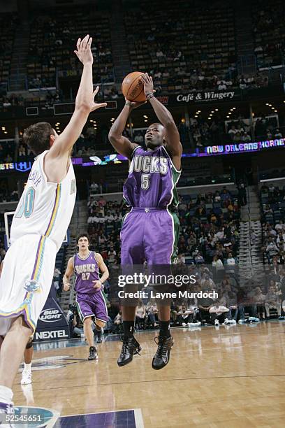 Anthony Goldwire of the Milwaukee Bucks shoots over Bostjan Nachbar of the New Orleans Hornets during the game on March 12, 2005 at the New Orleans...