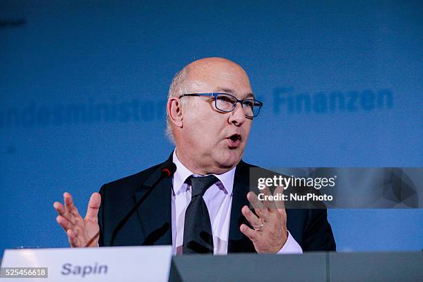 French Finance Minister Michael Sapin reacts during a press conference with German Finance Minister Wolfgang Schaeuble, German Vice Chancellor and...