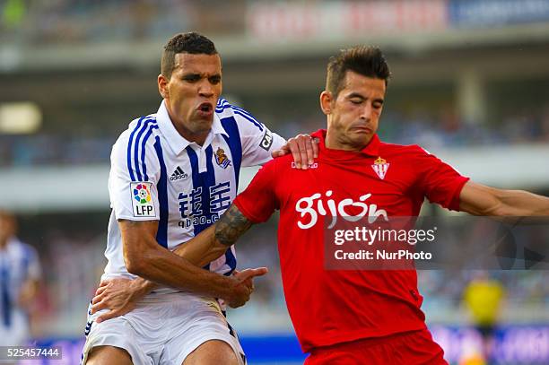 Jonathas of Real Sociedad duels for the ball with Luis Hernandez of Sporting Gijon during the Spanish league football match Real Sociedad vs Sporting...