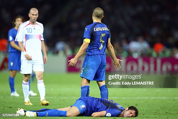 Fabio Cannavaro asks for an explanation as Marco Materazzi lies on the ground after receiving a head butt from Zinedine Zidane during the final of...