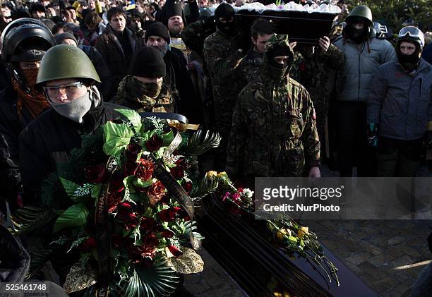 Tens of thousands of people walk a mourning during the funeral procession of the activist Mikhail Zhiznevsky, in Kiev, on Jan. 26, 2014 which was...