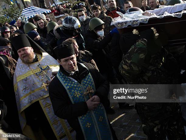 Tens of thousands of people walk a mourning during the funeral procession of the activist Mikhail Zhiznevsky, in Kiev, on Jan. 26, 2014 which was...