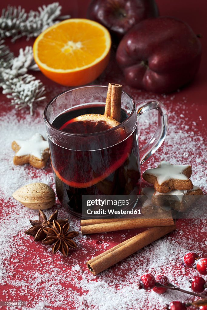 Glass of mulled wine with slice of orange and cinnamon stick