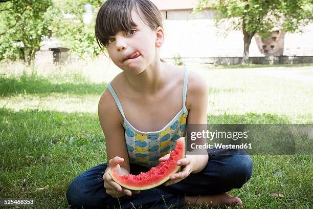 girl with slice of watermelon licking lips - juicy lips stock pictures, royalty-free photos & images