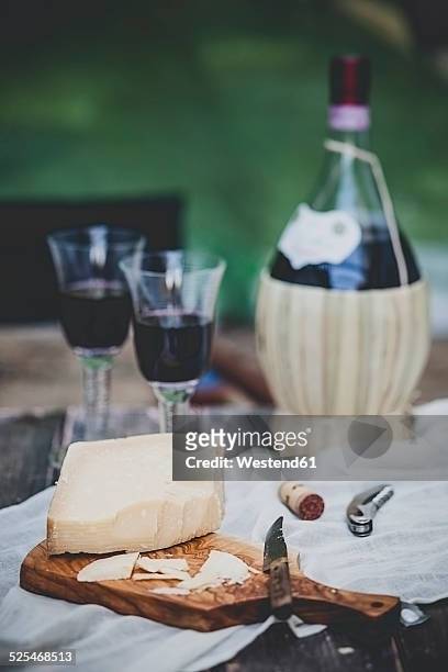 italian cheese grana padano, two glasses and bottle of chianti - grana padano bildbanksfoton och bilder