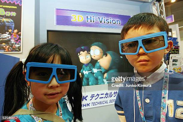 Children watch 3D Hi-Vision animation during the preview of the Tokyo International Anime Fair on April 1, 2005 in Tokyo, Japan. The fair, organized...