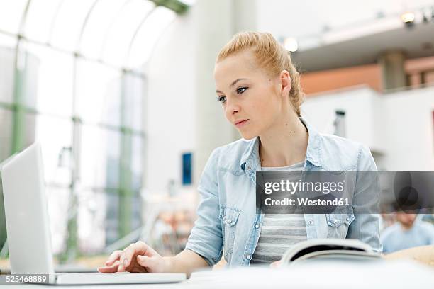 student learning in a university library - university of information technology in warsaw stock pictures, royalty-free photos & images