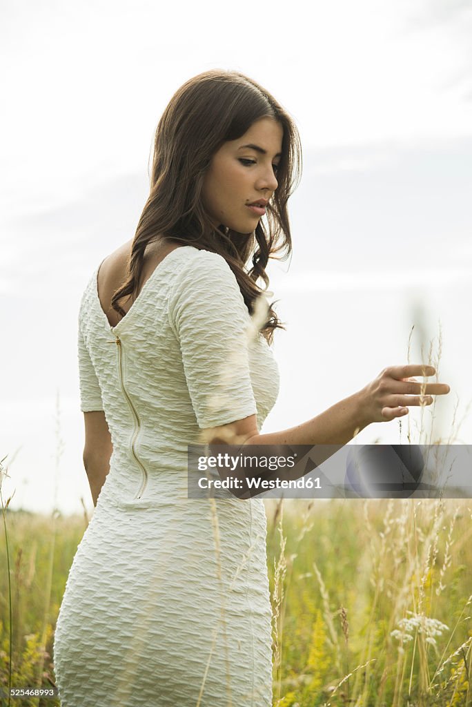 Young woman standing on flower meadow