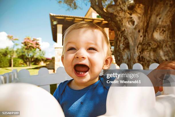 male baby with open mouth outdoors - baby tooth stock-fotos und bilder