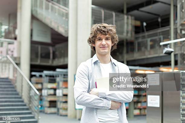 portrait of student in a university library - poland men stock pictures, royalty-free photos & images