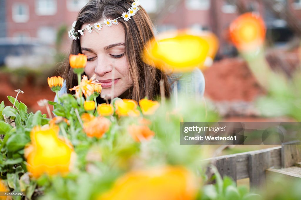 Portrait of smiling young woman enjoying flowers