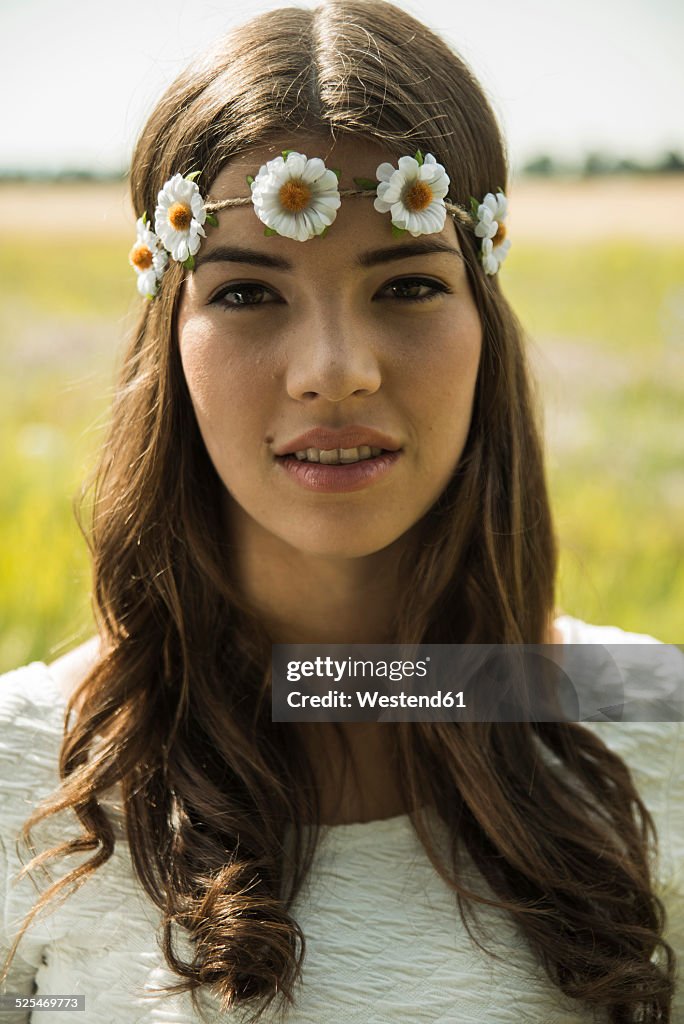 Portrait of young woman wearing floral wreath