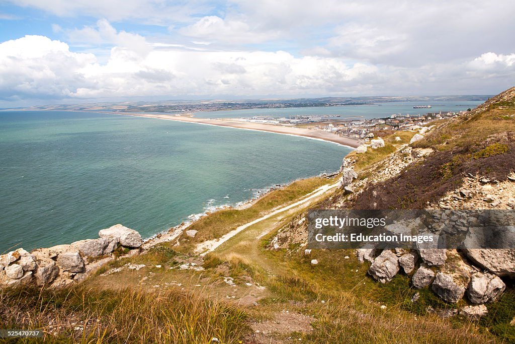 Chiswell village at the start of Chesil Beach with Weymouth harbor beyond, Isle of Portland, Dorset