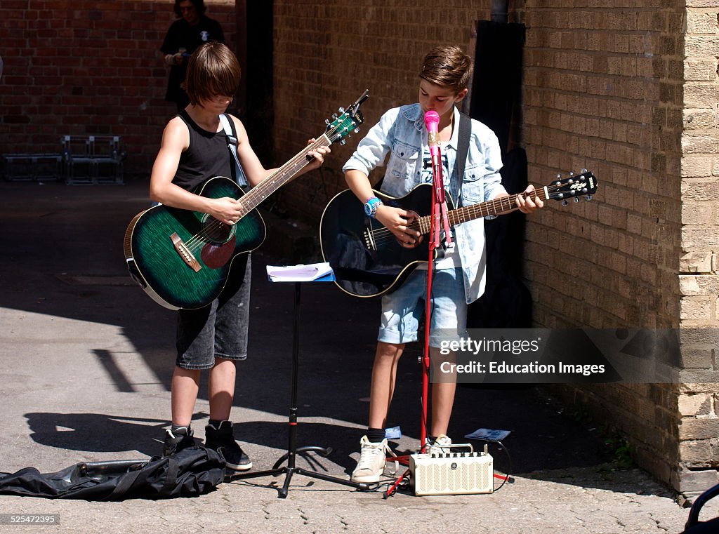 Two Children Busking on the streets of Cirencester, Gloucestershire